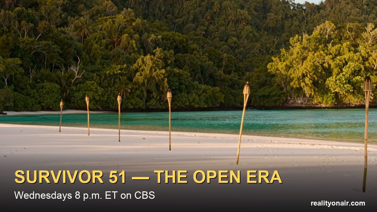 An empty tropical beach at golden hour with unlit bamboo torch poles planted in the sand